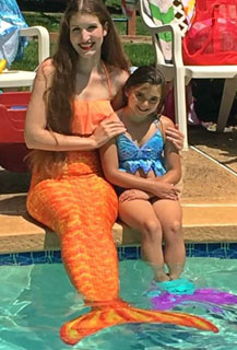 Costumed Mermaid Princess dressed in orange for Parties